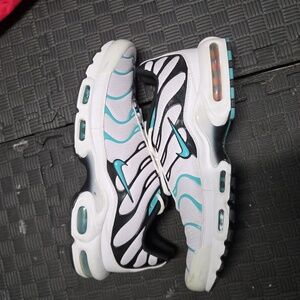 Nike Air Max Plus shoes in the "White Hyper Jade" colorway. 